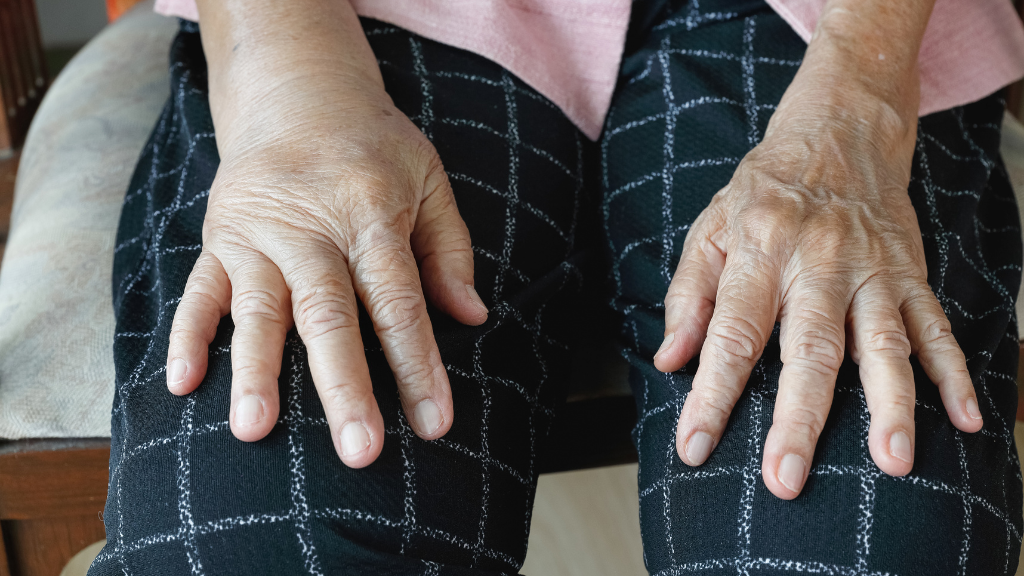 Person sitting with hands resting on knees